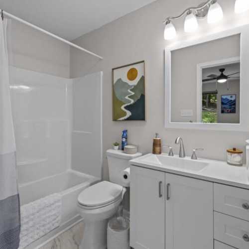 Bathroom 1: full bathroom with bathtub/shower combo; en suite to bedroom 1