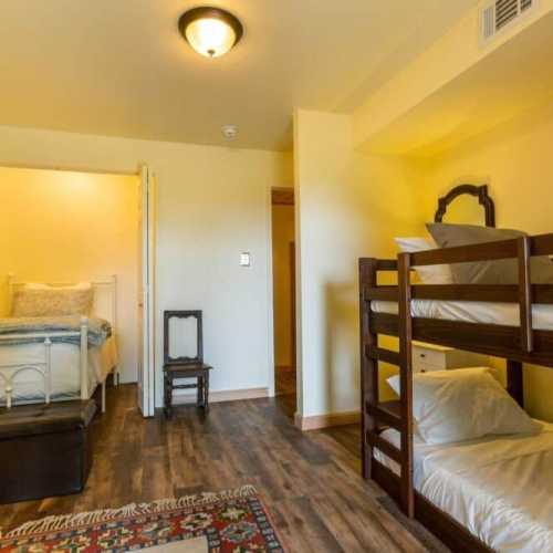 Bedroom #3: bunk bed and separate twin bed, lower level with access to the patio beneath the deck