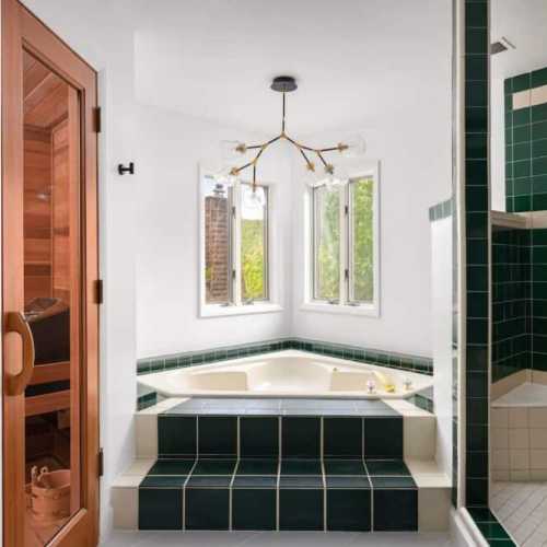 Bathroom 1: full bathroom with large shower, separate bathtub, and private sauna; en suite for bedroom #1