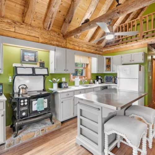 The antique kitchen oven/stovetop in this photo has been replaced with a brand-new and much more functional induction stovetop and oven.
