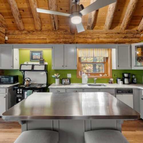 The antique kitchen oven/stovetop in this photo has been replaced with a brand-new and much more functional induction stovetop and oven.