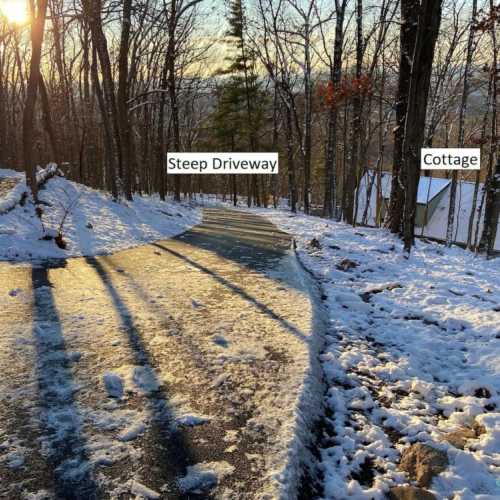 This is a parking pad large enough for two cars up near the road, in case the driveway is too slick to drive up or down. The driveway from the road down to the house is steep.  When it rains or snows and the road is slick, driving up and down the driveway (and the roads in the neighborhood) can be a challenge.