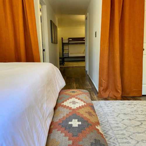 Bedroom #1: King bed is separated from bunk beds by curtains