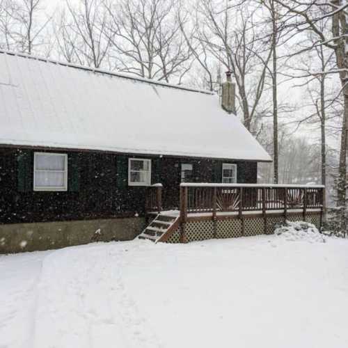 The cabin is beautiful with a fresh snow on the ground!