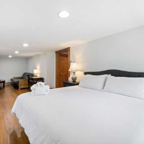Bedroom #1: King bed on 2nd floor w/ couch, TV, and en suite bathroom