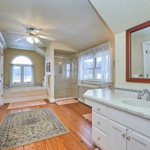 Bathroom #2: full bathroom with shower and separate bathtub, en suite to bedroom #2 on 2nd floor