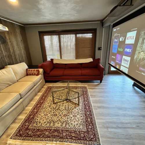 Basement living room with a projector screen