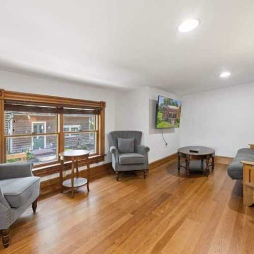 Bedroom #1: King bed on 2nd floor w/ couch, TV, and en suite bathroom