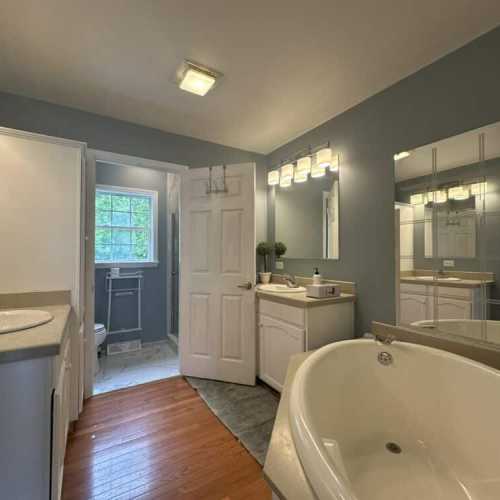 Bathroom #1: full bathroom with separate shower and bathtub; en suite to bedroom 1