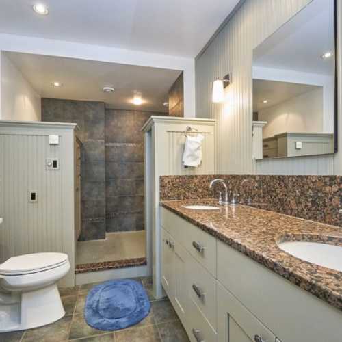 Bathroom #1: full bathroom with shower, en suite to bedroom #1 on the main floor