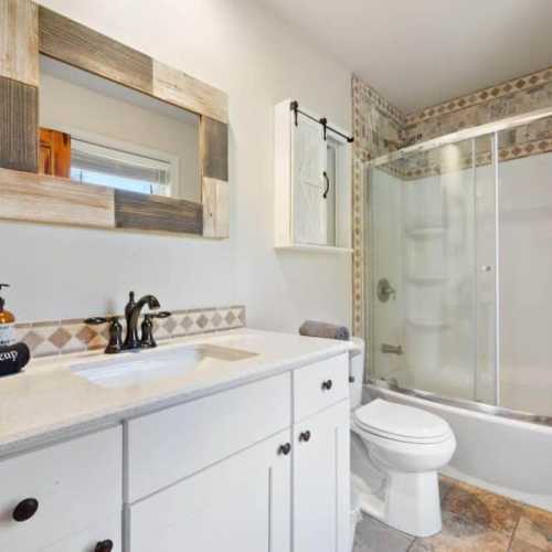 Bathroom #2: full bathroom w/ bathtub/shower combo on main floor; shared by bedroom #2 and #3