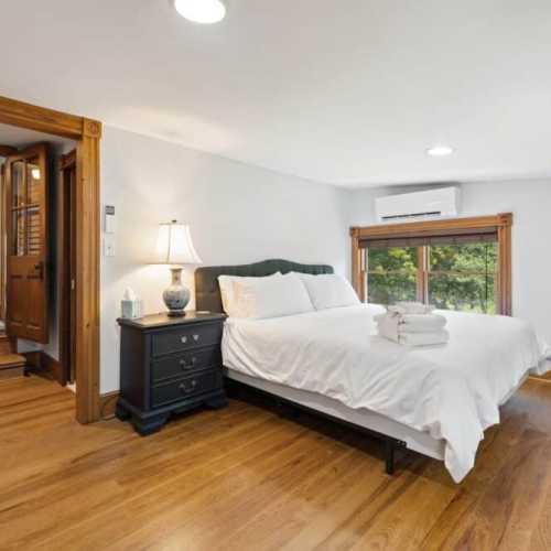 Bedroom #1: King bed on 2nd floor w/ couch, TV, and en suite bathroom