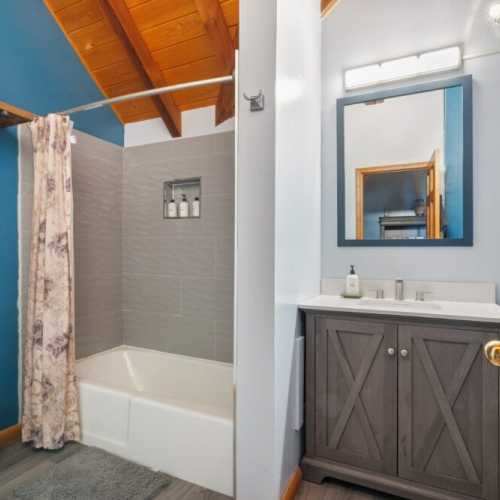 Bathroom 1: full bathroom with bathtub/shower combo; shared by bedrooms 1 and 2