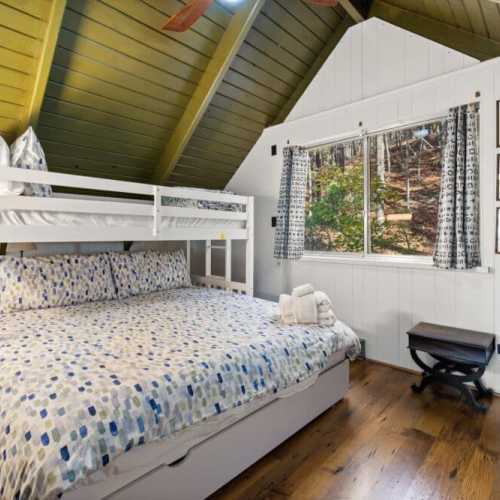 Bedroom #4: king bed with twin bunk above and twin trundle bed below; only accessible by walking through bedroom #3