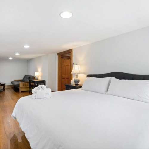 Bedroom #1: King bed on 2nd floor w/ couch, TV, and en suite bathroom