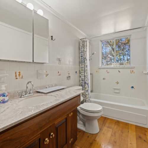 Bathroom #3: full bathroom with bathtub/shower combo, shared by bedroom #3 and #4