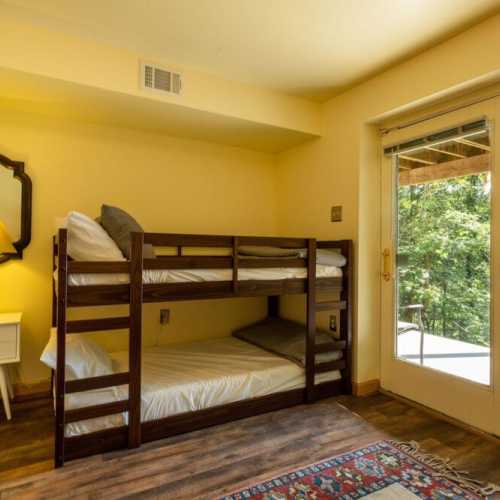 Bedroom #3: bunk bed and separate twin bed, lower level with access to the patio beneath the deck