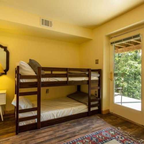 Bedroom #3: bunk bed and separate twin bed, lower level with access to the patio beneath the deck